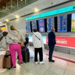 gulfnews_import_2024_04_19_Passengers-check-flight-information-on-screens-at-the-Dubai-International-Airport-in-Dubai-on-April-17–2024.–_18ef59f7463_large_converted